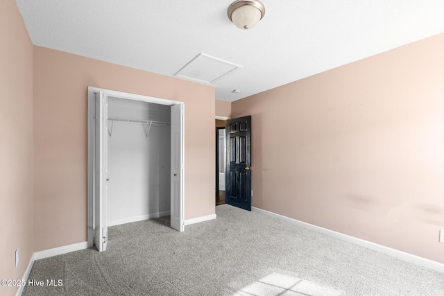 unfurnished bedroom featuring light colored carpet and a closet