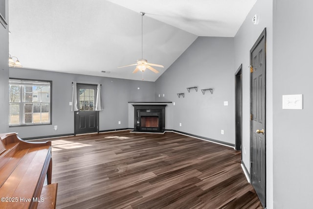 unfurnished living room featuring lofted ceiling, dark wood-type flooring, and ceiling fan