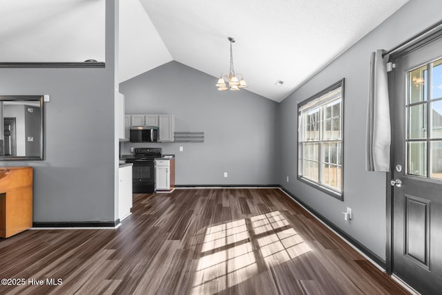 kitchen featuring dark wood-type flooring, lofted ceiling, black range with electric cooktop, a notable chandelier, and white cabinets