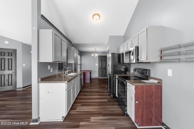 kitchen with an inviting chandelier, dark hardwood / wood-style floors, sink, and electric range