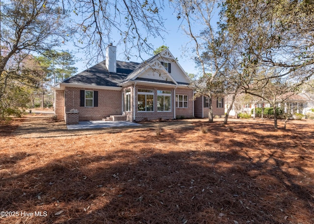 rear view of property with a patio area and a lawn