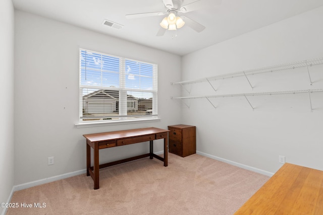 office area with light colored carpet, visible vents, and baseboards