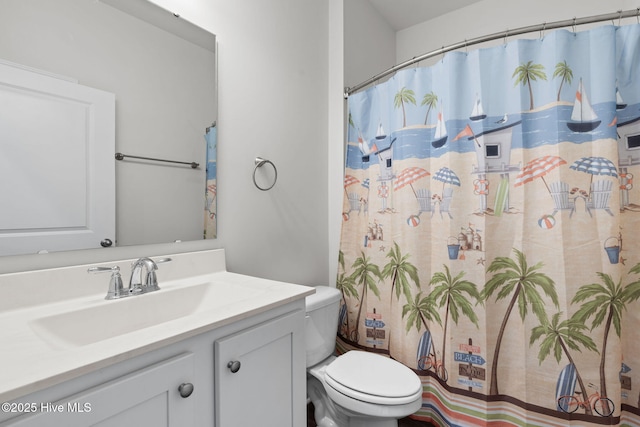 bathroom featuring curtained shower, vanity, and toilet