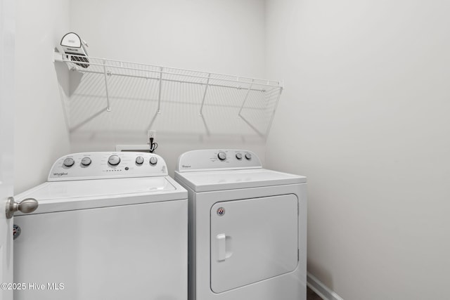 laundry area featuring laundry area, separate washer and dryer, and baseboards