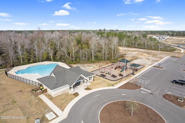 birds eye view of property with a forest view