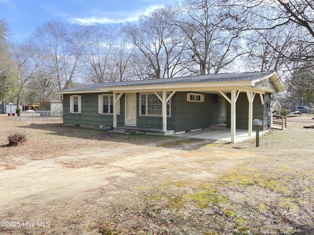 ranch-style home featuring a carport