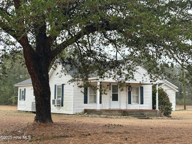 view of front facade with cooling unit and covered porch