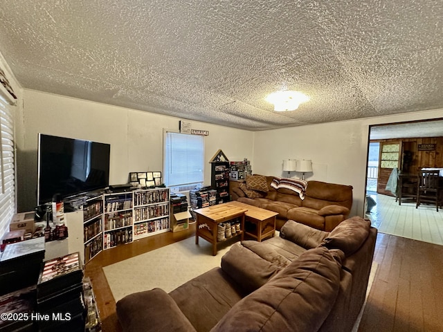 living room with hardwood / wood-style flooring and a textured ceiling