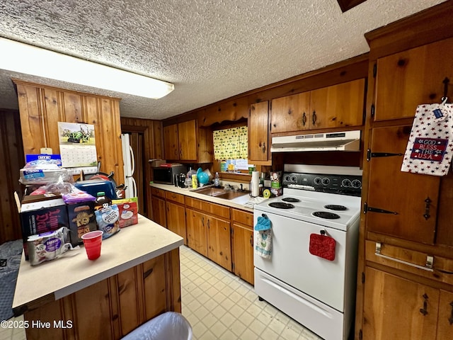 kitchen featuring white appliances, sink, and a textured ceiling