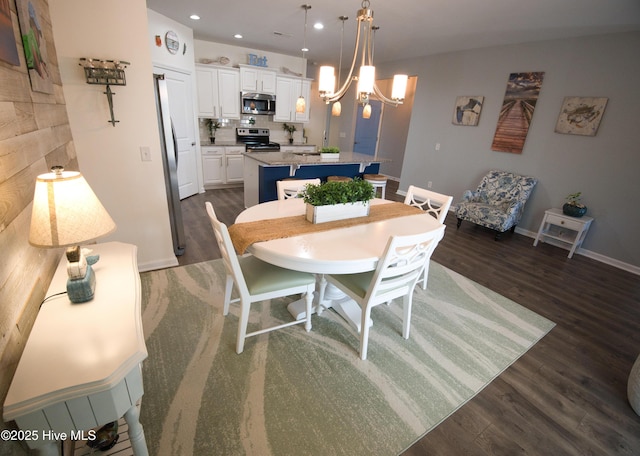 dining room featuring recessed lighting, dark wood finished floors, baseboards, and an inviting chandelier