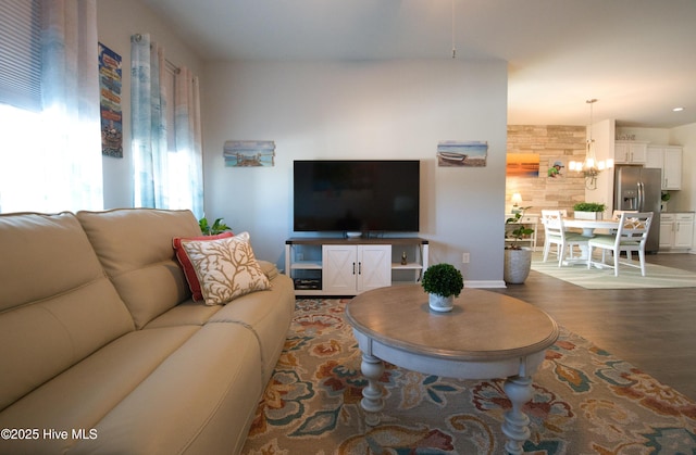 living area featuring baseboards and dark wood finished floors