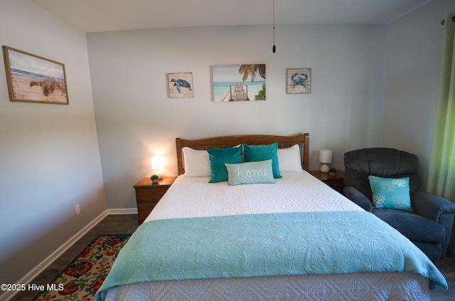 bedroom featuring baseboards and wood finished floors