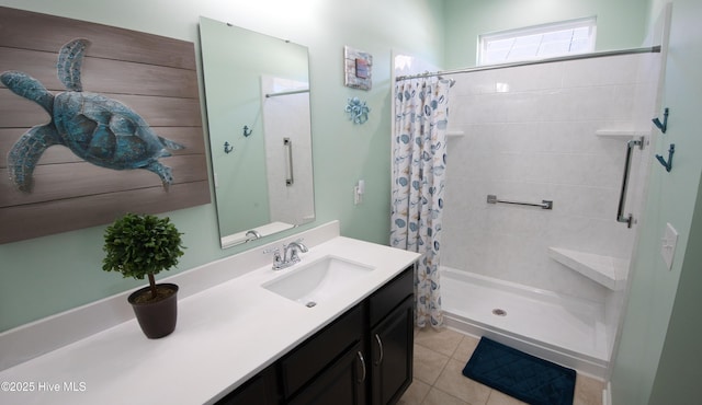 bathroom with a stall shower, tile patterned floors, and vanity