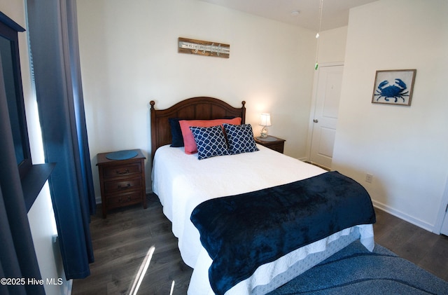 bedroom with dark wood-style flooring and baseboards