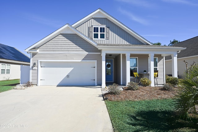 view of front facade with board and batten siding, covered porch, an attached garage, and concrete driveway