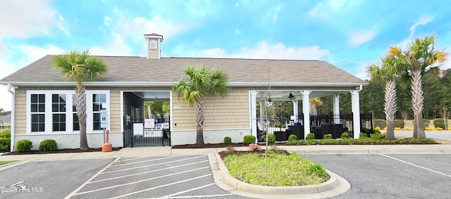 view of property with uncovered parking and a fenced front yard