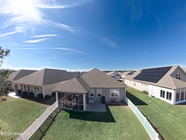 back of house featuring a patio area, a fenced backyard, roof with shingles, and a yard