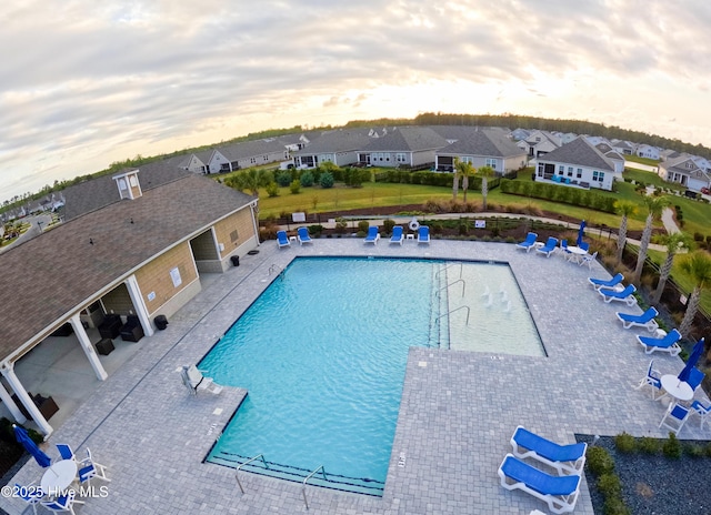 pool featuring a residential view and a patio