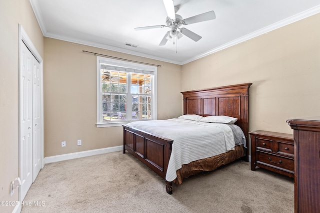 bedroom featuring baseboards, visible vents, light colored carpet, crown molding, and a closet