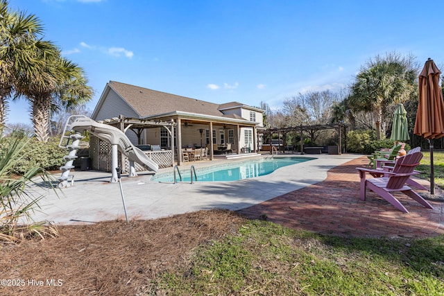 outdoor pool featuring a water slide, a patio area, and a pergola