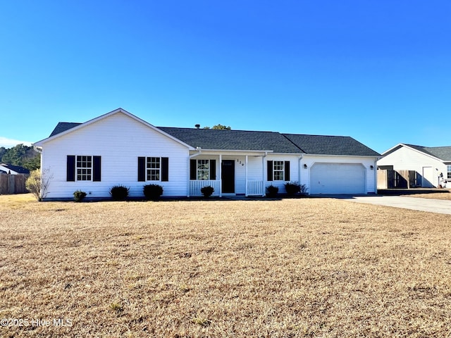 ranch-style house with a garage, a front yard, and covered porch