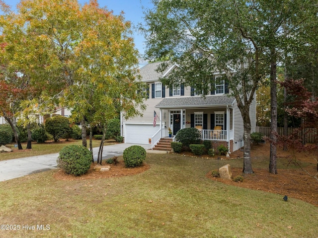 view of front of house featuring a garage, a front lawn, and a porch