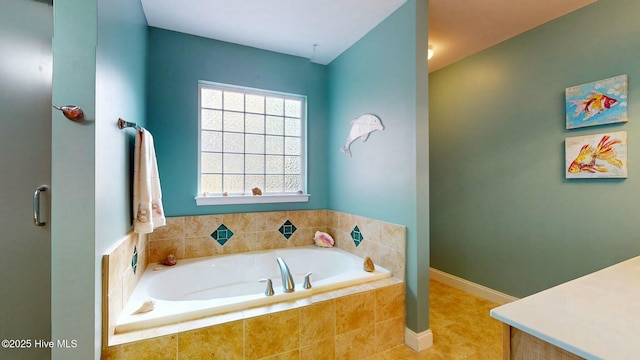 bathroom featuring a relaxing tiled tub and tile patterned flooring