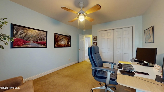 carpeted office featuring ceiling fan