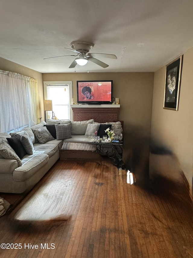 living area featuring ceiling fan and wood finished floors