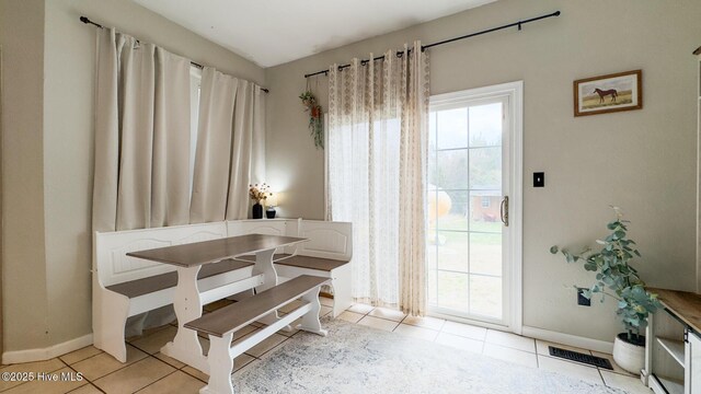 bedroom featuring ceiling fan, light wood-style flooring, and a barn door