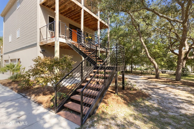 view of property exterior with stairway and an attached garage