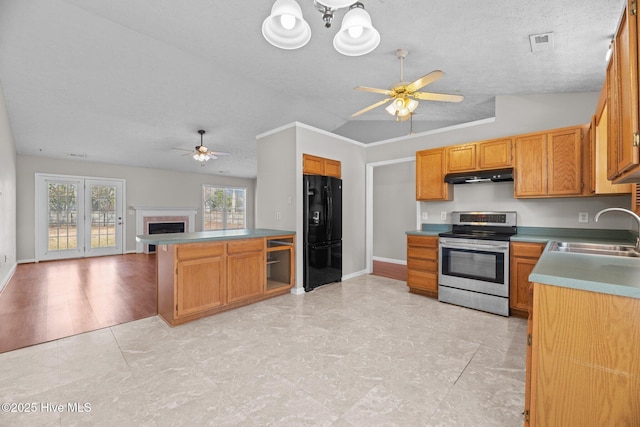 kitchen featuring electric stove, sink, a textured ceiling, ceiling fan with notable chandelier, and black refrigerator