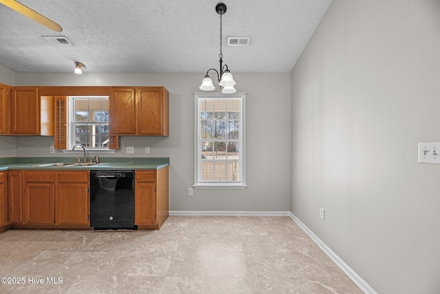 kitchen with hanging light fixtures, a healthy amount of sunlight, sink, and black dishwasher