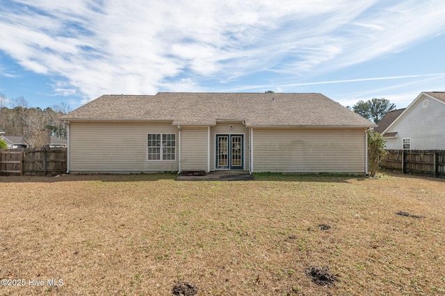 rear view of house featuring a yard