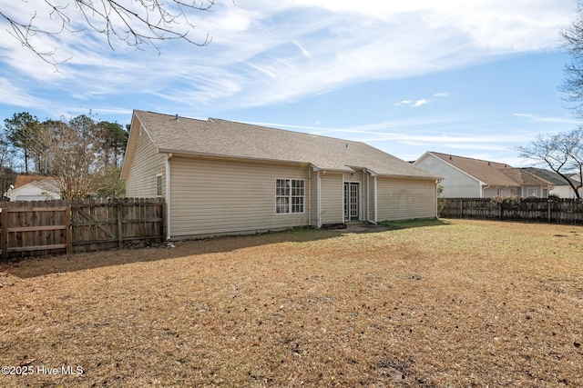 rear view of property with a lawn