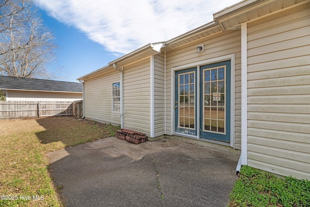 doorway to property with a yard and a patio