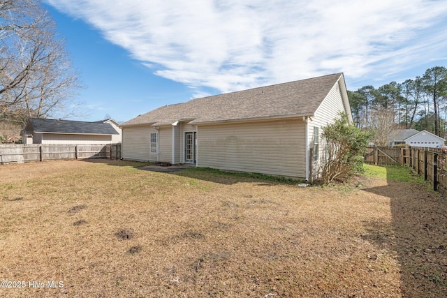 rear view of property featuring a yard