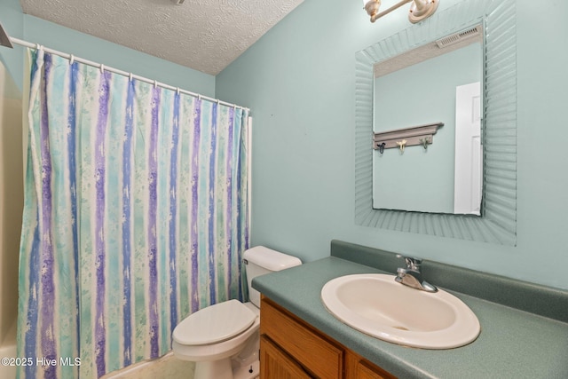 bathroom featuring a textured ceiling, toilet, vanity, and a shower with curtain