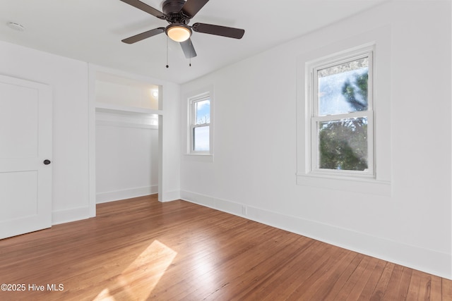 unfurnished bedroom with wood finished floors, a ceiling fan, and baseboards
