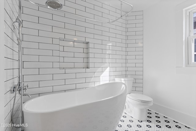 bathroom with tile patterned flooring, tub / shower combination, and toilet