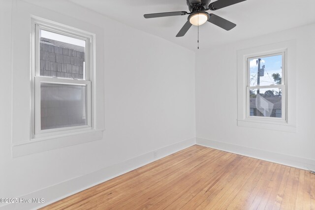 unfurnished room featuring wood finished floors, a ceiling fan, and baseboards
