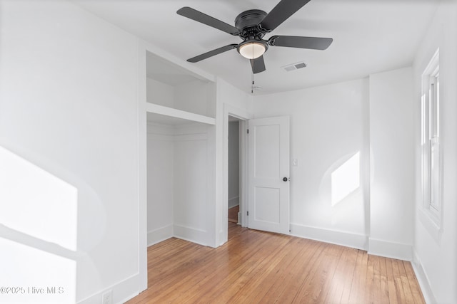 unfurnished bedroom featuring light wood-style flooring, visible vents, ceiling fan, and baseboards