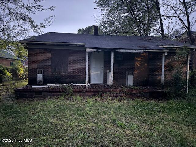 617 Myrtle Ave, Rocky Mount, NC 27801 - view of front of property featuring a front yard, brick siding, and a chimney