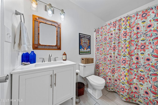 bathroom featuring toilet, vanity, and walk in shower