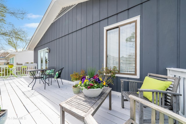 wooden terrace with outdoor dining area