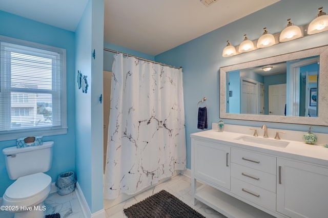 2017 W Beach Dr, Oak Island, NC 28465 - full bath featuring marble look tiles, vanity, toilet, and a shower with curtain