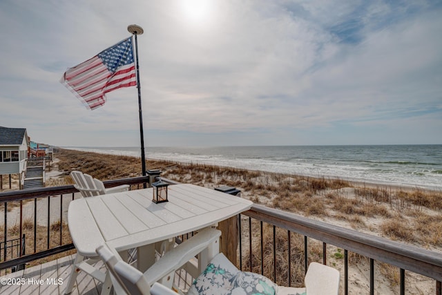 2017 W Beach Dr, Oak Island, NC 28465 - wooden terrace featuring view of water and beach