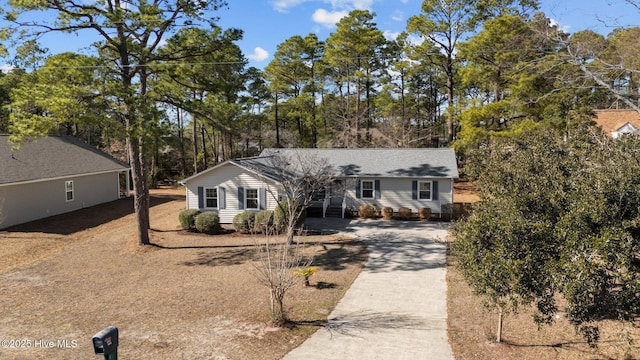 single story home featuring concrete driveway