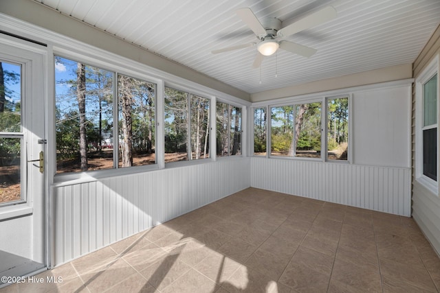 unfurnished sunroom featuring ceiling fan