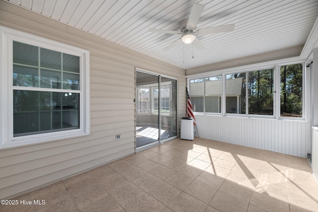 unfurnished sunroom featuring a ceiling fan